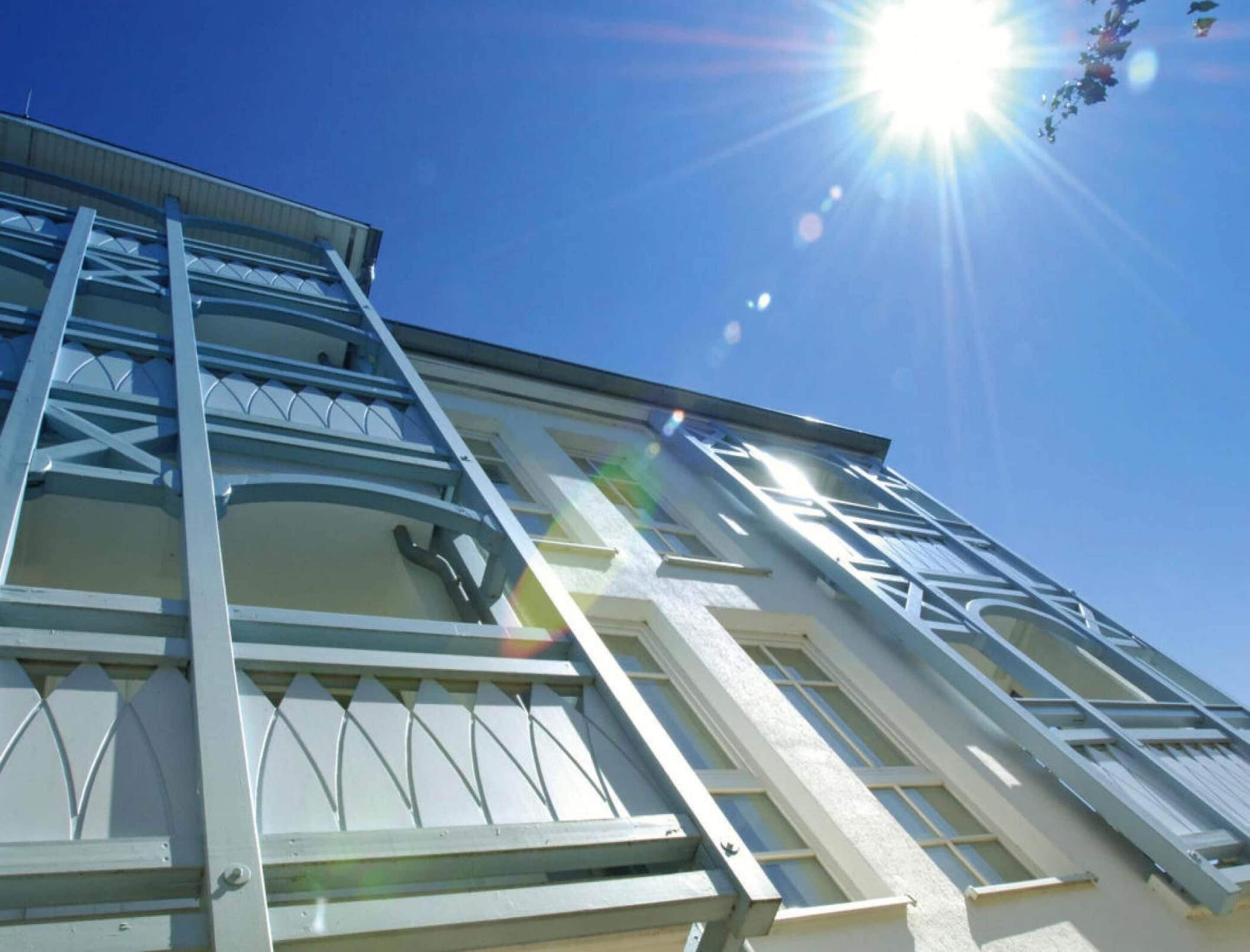 A building with a modern architectural design, featuring large windows and a prominent staircase.
