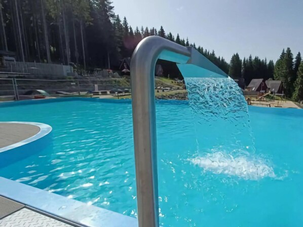 A swimming pool with a water feature. - Holiday Complex Erzgebirge Idyll, Breitenbrunn (Breitenbrunn/Erzgeb.)