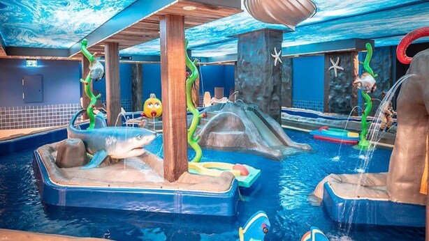 An indoor water park with slides, wave pools, and various play structures. - Ferien- und Freizeitpark Weissenhauser Strand (Wangels)