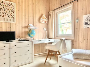 A room with wooden panel walls, a desk with a globe, a chair, a bed, and a window with curtains. - Holiday Home Seerose With Sauna on Lake Dummer, Dummer (Dümmer)