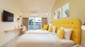 A hotel room with two beds, a TV, a desk, and a view of the outdoors. - Bloom Hotel Khandala (Mawal)