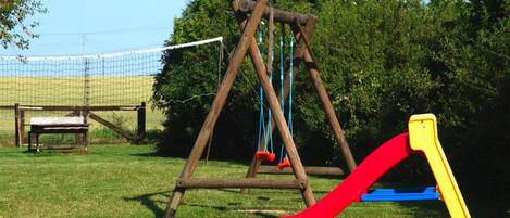 A playground with a swing set and a slide.