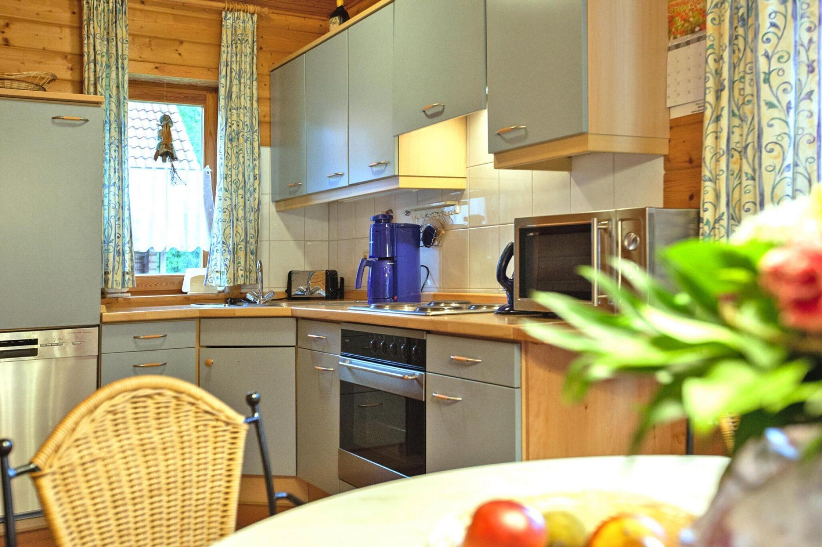 A kitchen with grey cabinets, a microwave, a coffee maker, and a dishwasher.