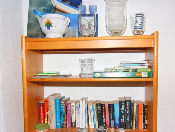 A bookshelf with various books and decorative items.