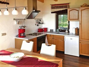 Functional kitchen with stove, sink, and refrigerator, perfect for meal preparation and small gatherings.