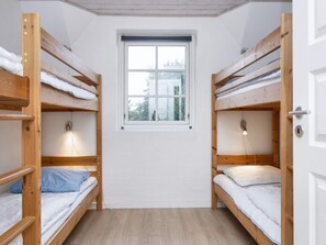 A dormitory room with bunk beds, a window, and a light fixture. - 4 Star Holiday Home in Ulfborg (Ulfborg)