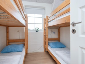 A dormitory room with bunk beds, a window, and a door. - 4 Star Holiday Home in Ulfborg (Ulfborg)