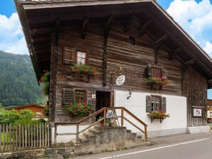 A wooden building with a sign for the Alpin- und Tourismusmuseum, featuring flower boxes and a staircase leading to the entrance. - Holiday Home in Gaschurn Near Town Center (Gaschurn)