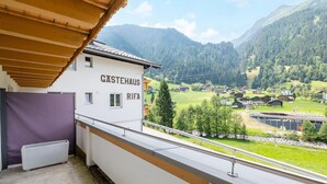 A building labeled "Gästehaus Rifa" with a view of a mountainous landscape and a village below. - Spacious Apartment Near the Centre and ski Resort (Gaschurn)