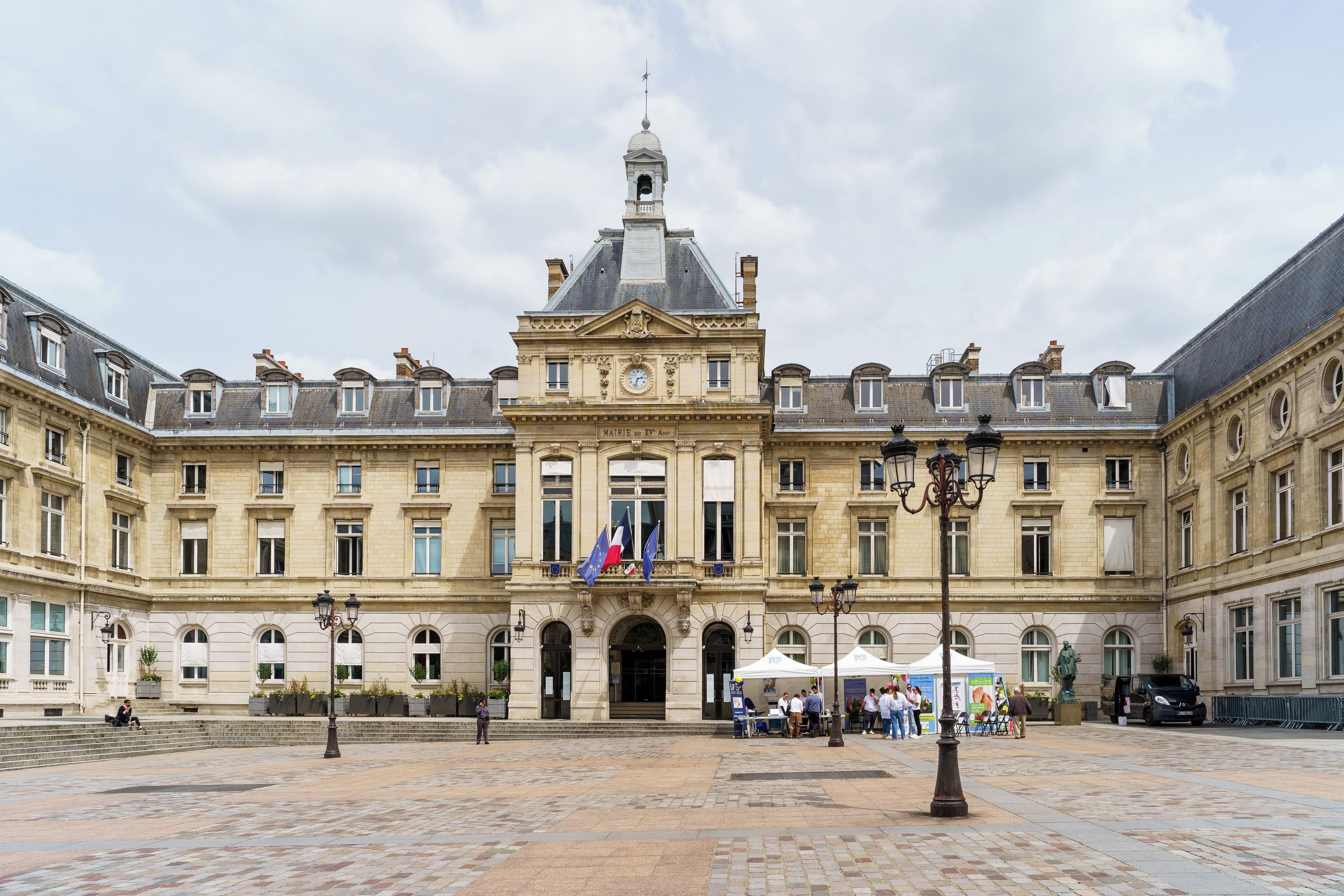 A historic building with a central entrance, multiple windows, and a clock tower.