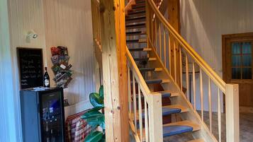 A wooden staircase with blue steps and a wooden railing.