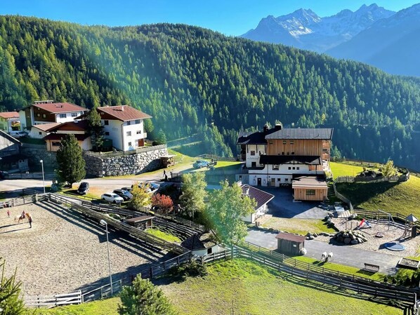 A mountain resort with multiple buildings, a horse riding area, and a playground. - Talissa at Organic & Riding Stables of Veitenhof (Umhausen)