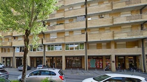 A multi-story building with a ground-level commercial space and upper residential units. - Apartment in Caorle Near Seabeach (Caorle)