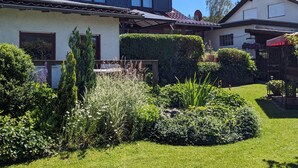 A two-story house with a well-maintained garden, a satellite dish, and a visible garage. - Apartment in Bad Wunnenberg Near Ski Willingen (Bad Wuennenberg)