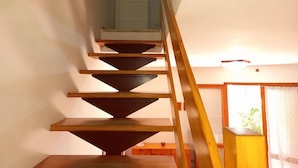 A wooden staircase with a handrail leading to a landing. - Attractive Villa With Garden (Ravenna)