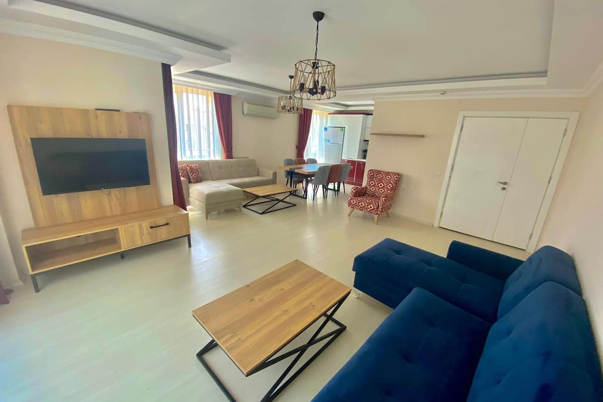 Deluxe Apartment | Living area | 24-inch TV with satellite channels