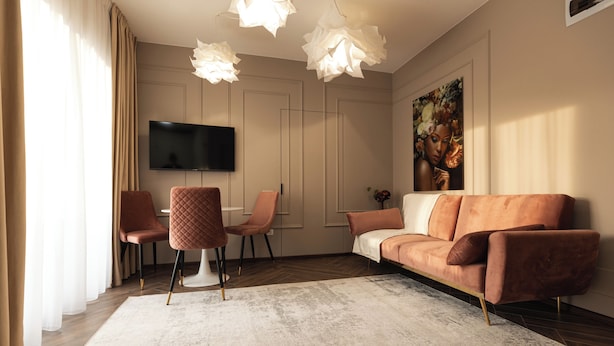 A modern living room with a sofa, two armchairs, a coffee table, and a flat-screen TV mounted on the wall. - Nest Inn Charm Apartment (Baia Mare)