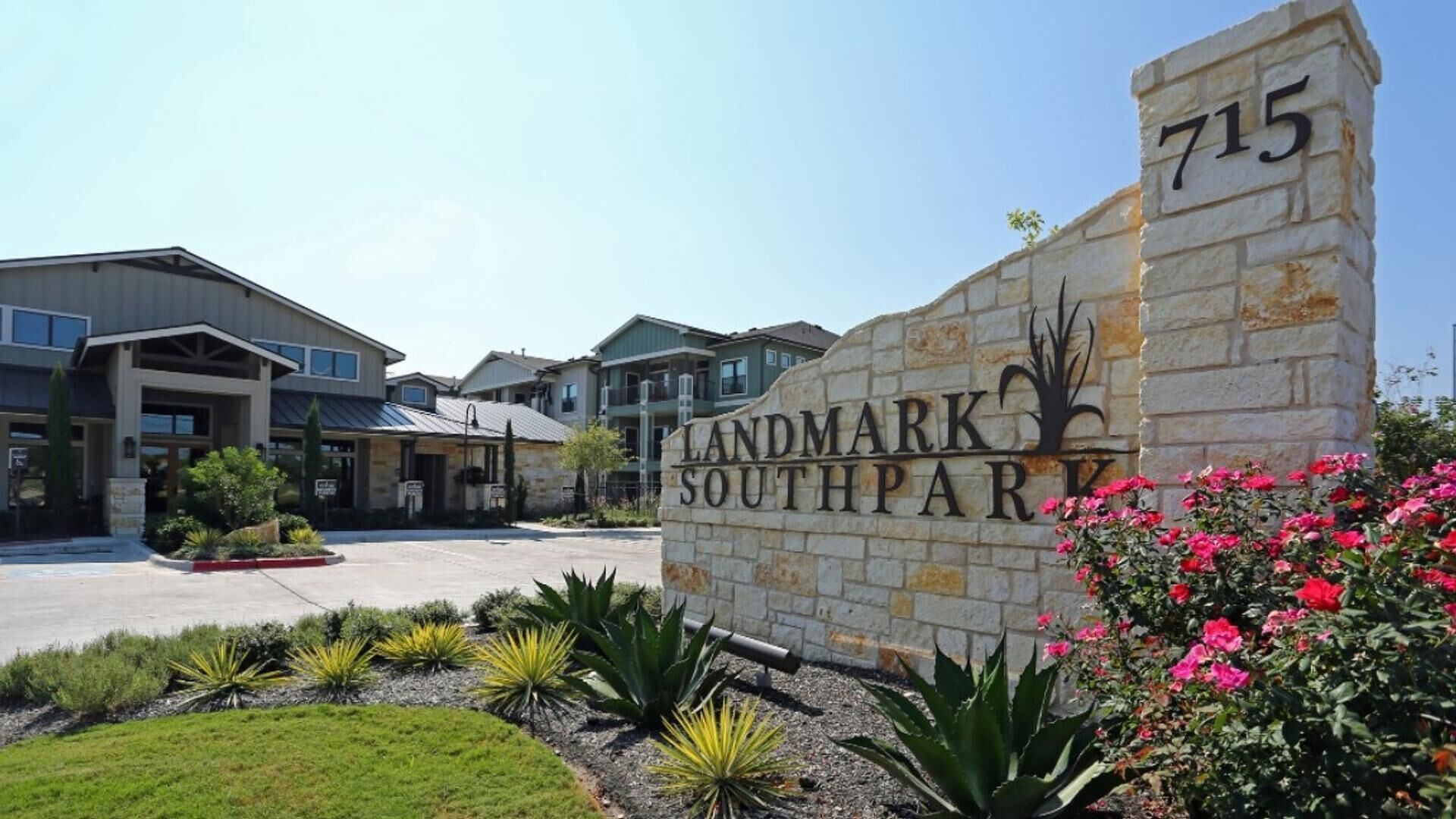 A residential complex named Landmark SouthPark with a stone sign, modern buildings, and landscaped gardens.