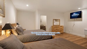 A bedroom with two beds, a TV, and a dresser. - Downtown Friday Harbor! Newly Built! BL (Friday Harbor)