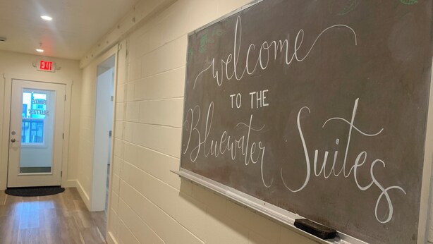 A hallway with a sign reading "Welcome to the Bluwater Suites." - Downtown Friday Harbor! Newly Built! PM (Friday Harbor)