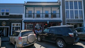 A building with a two-story structure, a covered porch, and a sign for a Chinese Teriyaki Sushi restaurant. - Downtown Friday Harbor! Newly Built! PM (Friday Harbor)