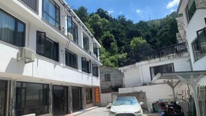 A two-story building with large windows and a car parked in front. - lingfeng63 (Yueqing)
