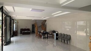 A spacious room with a large dining table, chairs, and a sofa. - lingfeng63 (Yueqing)
