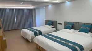 A hotel room with two beds, a wooden desk, and a window with curtains. - lingfeng63 (Yueqing)