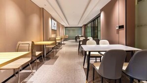 A modern conference room with long tables and chairs, a neutral color scheme, and a glass partition wall. - Bai Man Hotel (Guangzhou Financial City Tangxia Metro Station) (Guangzhou)