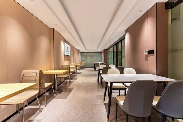 A modern conference room with long tables and chairs, a neutral color scheme, and a glass partition wall. - Bohan Hotel (Guangzhou Olympic Sports Center – Tangxia Metro Station Branch) (Guangzhou)