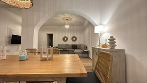 A dining area with a wooden table, chairs, and a buffet setup.