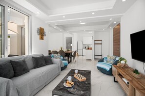 A modern living room with a sofa, coffee table, and TV.