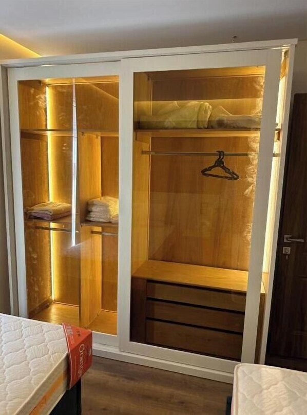 Ample storage space is available in this walk-in closet with a sliding door and hanging rod for clothes.