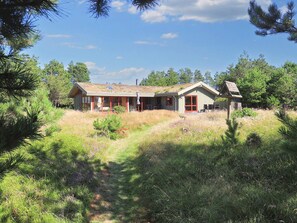 A single-story house with a large porch, surrounded by a natural landscape. - 6 Person Holiday Home in Blokhus (Blokhus)