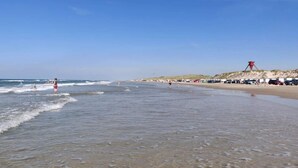 A beach with clear skies, waves, and a sandy shore. - 6 Person Holiday Home in Blokhus (Blokhus)