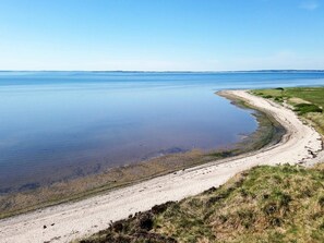 A coastal landscape with a sandy beach and calm water. - 4 Star Holiday Home in Gedsted (Gedsted)