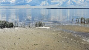 A calm lake with a clear sky and a sandy shore. - 4 Star Holiday Home in Gedsted (Gedsted)