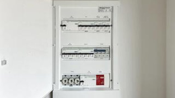 A white electrical panel with multiple circuit breakers and switches. - 8 Person Holiday Home in Romo (Rømø)