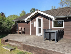 A wooden house with a deck, a door, and a window. - 4 Star Holiday Home in Hadsund (Hadsund)