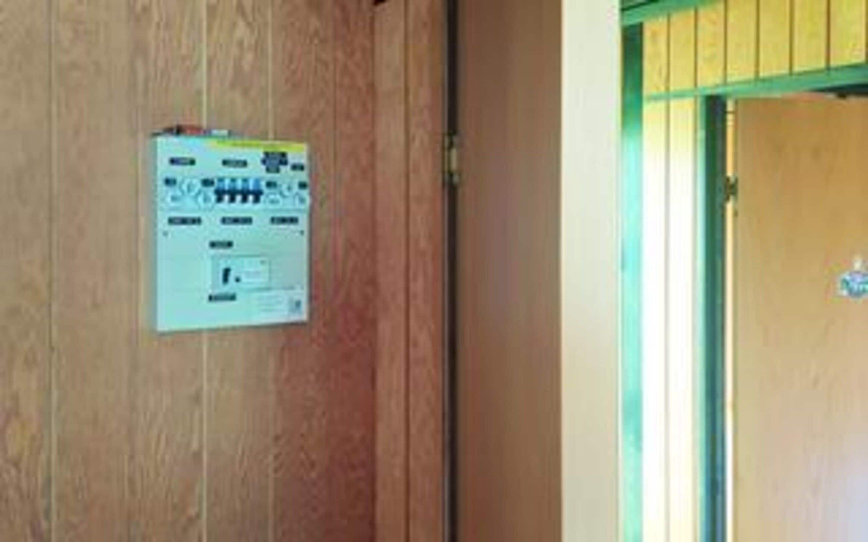 A wooden door with a control panel attached to it.