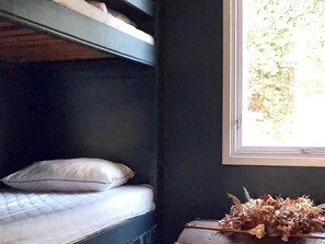 A bunk bed with a pillow and a window with a view of greenery. - 4 Star Holiday Home in Uddevalla (Uddevalla)