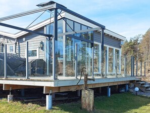 A modern house with a large glass extension, wooden deck, and a garage. - 4 Star Holiday Home in Skjeberg (Sarpsborg)