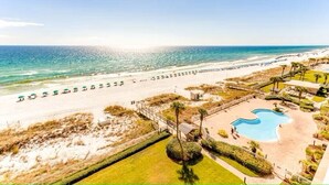 A beach resort with a swimming pool, beach umbrellas, and a clear view of the ocean. - Stunning Gulf front condo, shorter stays welcomed, great rates. (DESTIN)