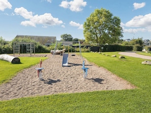 A playground with sand play area, swings, and a slide. - 4 Star Holiday Home in Hejls (Hejls)
