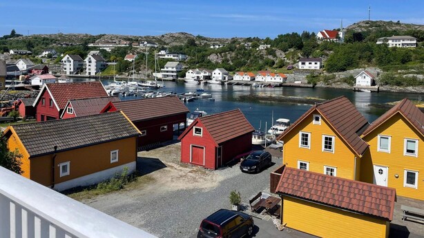A coastal village with colorful houses, a marina, and boats. - 6 Person Holiday Home in Bomlo (Bomlo)