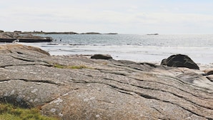 A rocky shoreline with a pier extending into the water. - 4 Star Holiday Home in Varberg (Varberg)