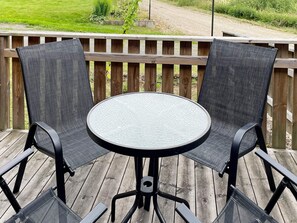 A round table with two chairs on a wooden deck. - 4 Star Holiday Home in Svangsta (Svangsta)