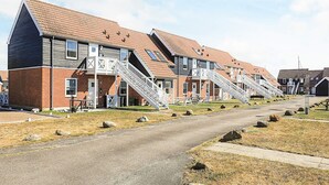 A row of modern apartment buildings with external staircases leading to the entrance. - 5 Person Holiday Park Home in Borre (Borre)