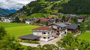 A residential area with houses featuring sloped roofs, solar panels, and a mix of modern and traditional architecture. - Chalet in Zillertal Near Ski Slopes (Ramsau im Zillertal)