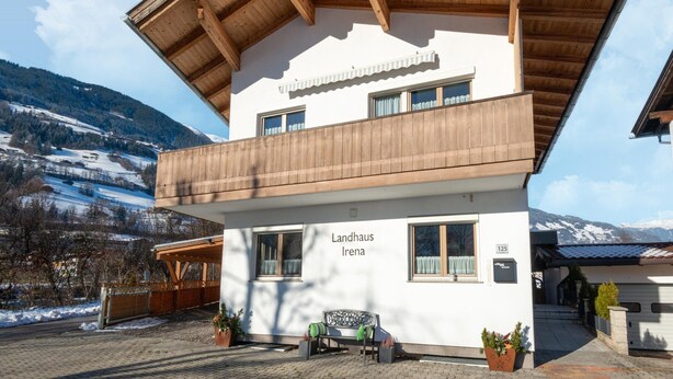A two-story building with a wooden balcony and a sign reading "Landhaus Irena." - Chalet in Zillertal Near Ski Slopes (Ramsau im Zillertal)